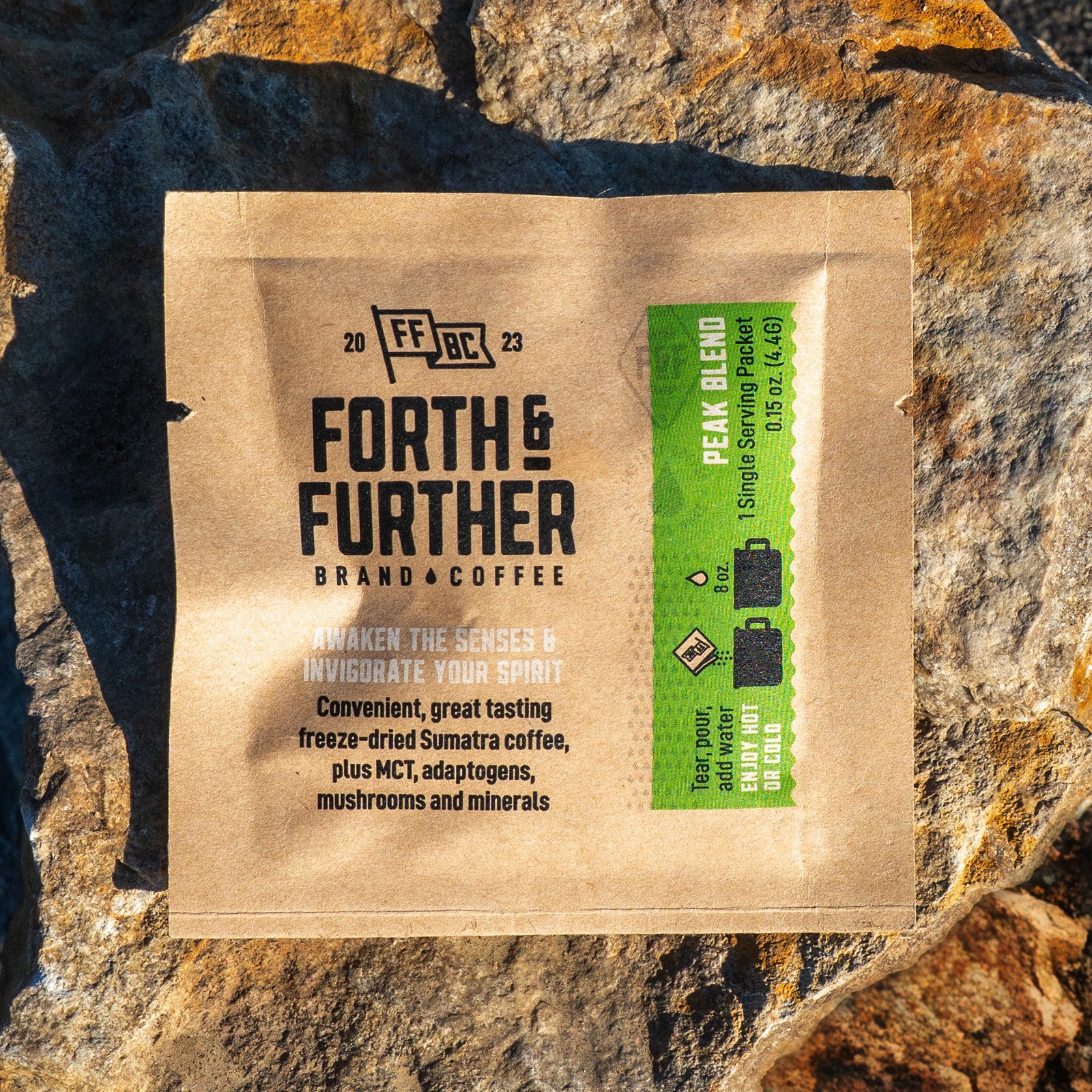 Forth & Further compostable coffee packaging on a stone background