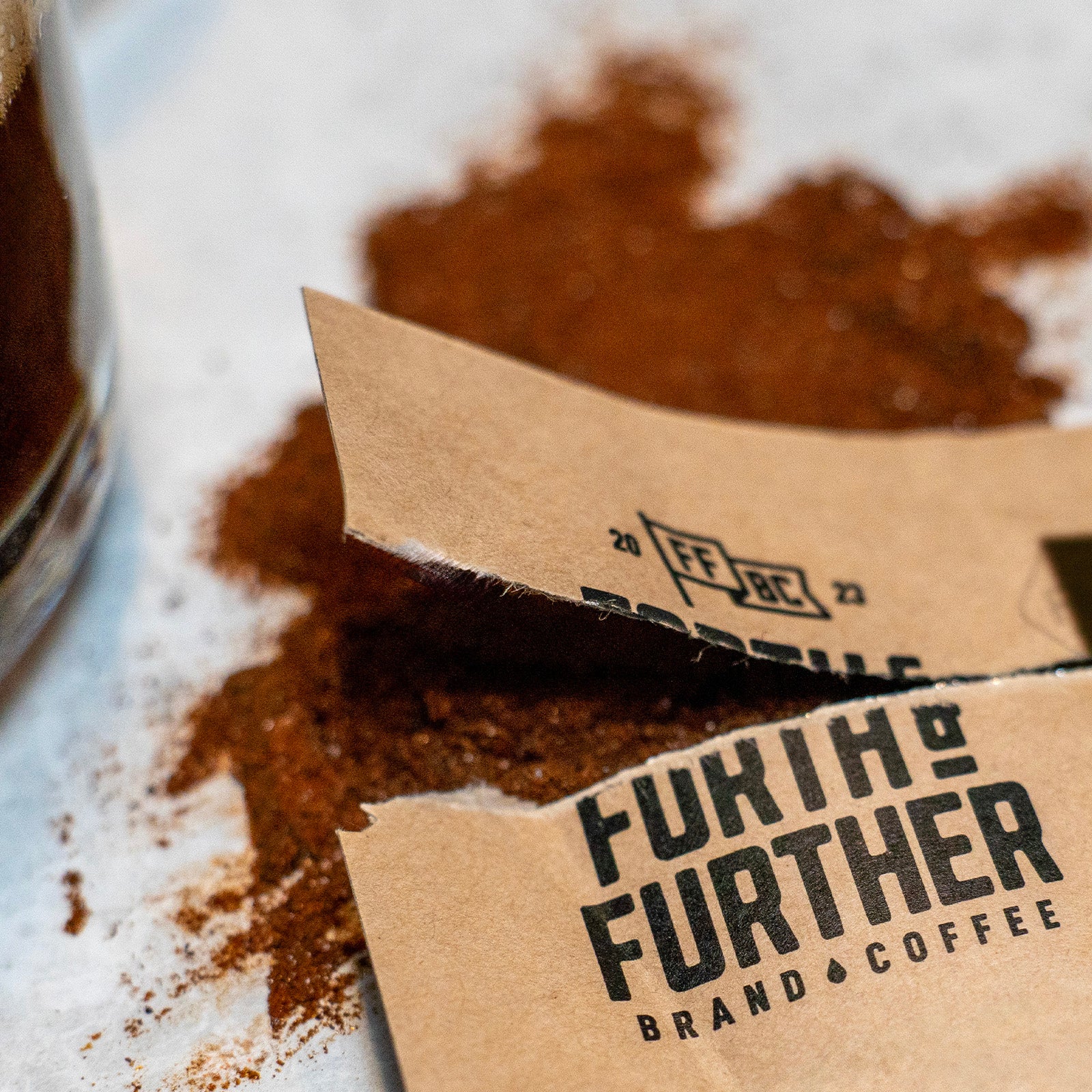 Forth and Further compostable packet torn open with Sumatra Black freeze-dried coffee spilling out