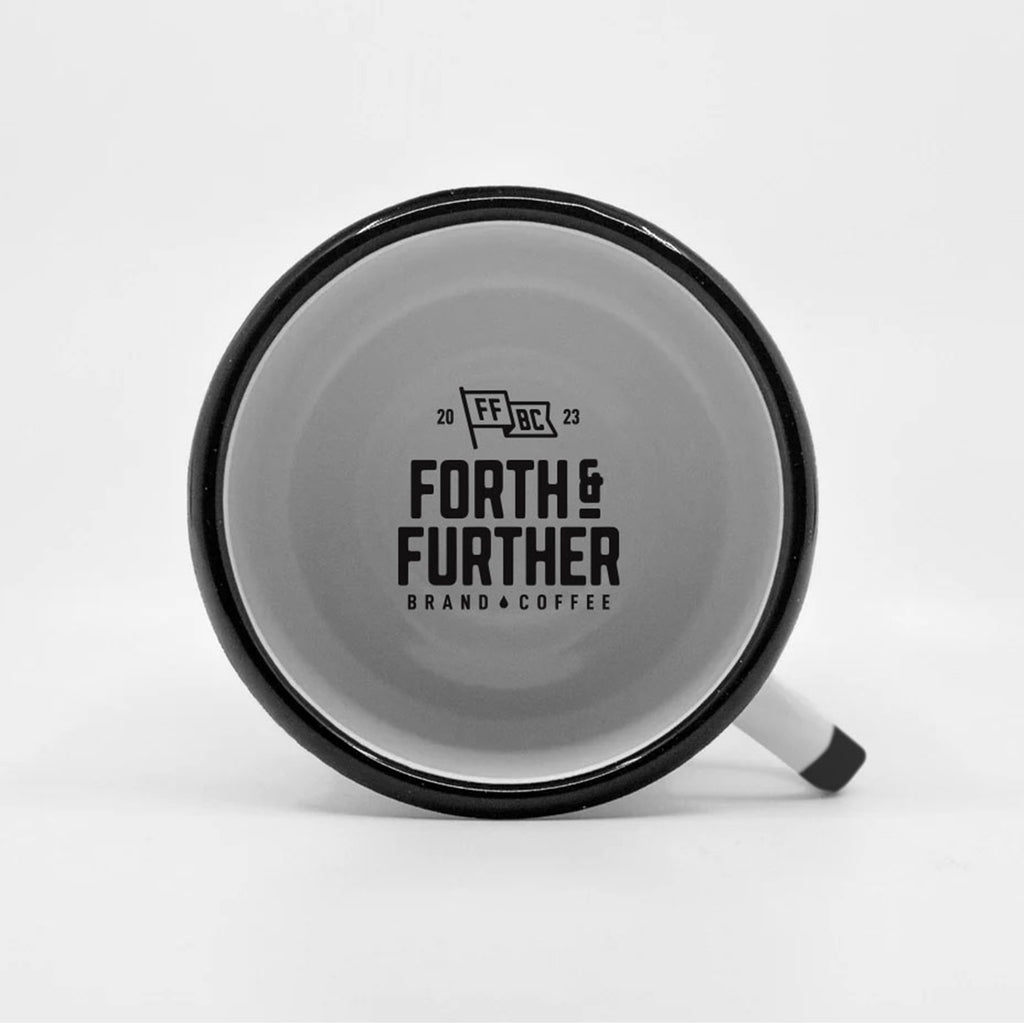 White enamel camp mug with black rim and handle, featuring 'Forth & Further' branding inside